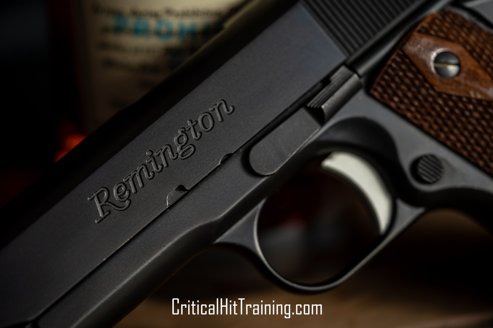 Close-up image of a Remington 1911 pistol, showcasing its classic design with a sleek steel frame, textured grips, and precision detailing, displayed on a neutral background.